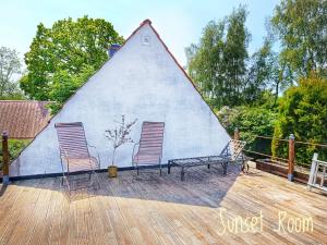 a house with two chairs sitting on a deck at Villa Sandäng in Löderup