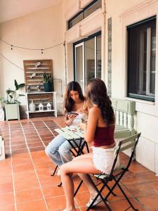two women sitting at a table on a patio at Ocean House in Ferrel