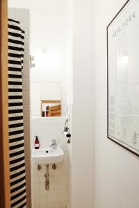 a bathroom with a sink and a mirror at Comfy open-space apartment in Warsaw Zoliborz in Warsaw