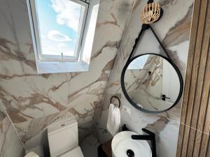 a bathroom with a mirror and a sink at Ambiance Aframe in Câmpulung Moldovenesc +112 photos