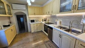 a kitchen with yellow cabinets and a sink at Old Town Pearl in Rhodes Town