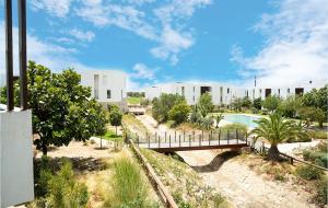 a bridge over a river in front of a building at Modern&Luxe Apt in Taghazout Bay in Taghazout