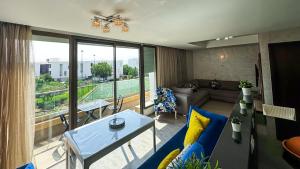a living room with a couch and a table at Modern&Luxe Apt in Taghazout Bay in Taghazout