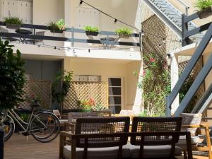 a patio with tables and chairs and bikes on a building at Hotel de Paris in La Rochelle