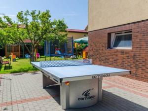 a ping pong table in front of a brick building at Róża Wiatrów in Rowy