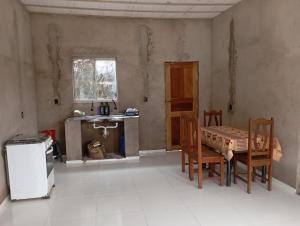 a kitchen with a table and chairs in a room at Casa em mosqueiro in Belém
