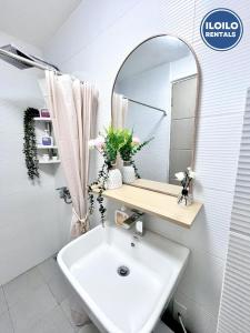 a bathroom with a sink and a mirror at Modern Studio Comfort at Bernwood Tower in Iloilo City +5 photos