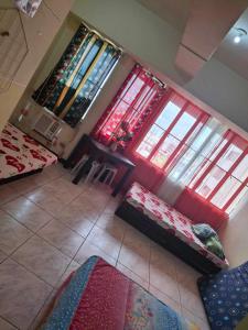 a living room with a couch and two windows at Condominium 7th in Cebu City