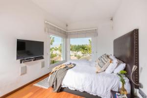 A bed or beds in a room at Ocean Views Luxury Villa next to beach