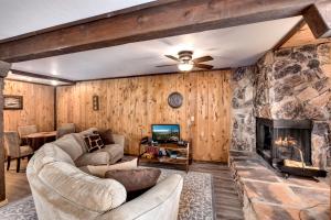 a living room with a couch and a fireplace at Snowflake Chalet condo in Stateline