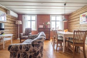 a living room with a dining room table and chairs at Villa ÕU apartments in Pärnu