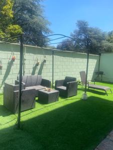 a patio with two chairs and a table in a yard at Casa con Giardino in Seregno