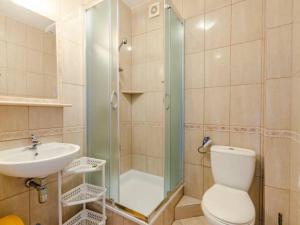 a bathroom with a shower and a toilet and a sink at Róża Wiatrów in Rowy +64 photos