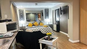 a large living room with a couch and a living room at Artzys Studio in Northriding