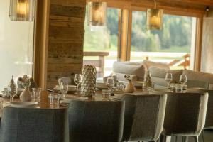 a dining room with a table and some chairs and a table and chairsktop at La Clusaz chalet Anthocyane 14 people, heated pool in La Clusaz