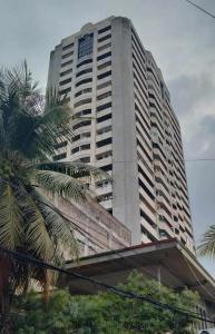 a tall building with palm trees in front of it at Condotel Cebu City in Cebu City +13 photos