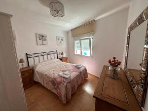 a bedroom with a bed and a mirror and a table at Pisos A Barca in Muxia