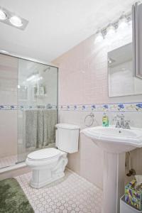a bathroom with a white toilet and a sink at Hutchinson Island Resort-style Beachside Condo in Fort Pierce