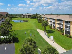 two people playing golf on a golf course in a resort at Hutchinson Island Resort-style Beachside Condo in Fort Pierce