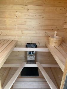 a inside of a sauna with a stove in it at Domki w sadzie Wapnica koło Międzyzdrojów in Wapnica