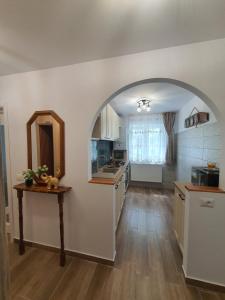 a kitchen with an archway in the middle of a room at BicazApart in Bicaz