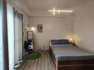 a small bedroom with a bed and a window at Cozy Staycation Near Cebu Airport with Pool & Gym , Free Wifi in Pusok +30 photos