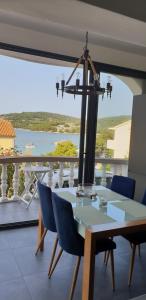 a dining room table with a view of the water at Apartments Perina Tisno in Tisno