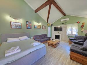 a bedroom with a bed and a living room at Luka's Family Comfort Apartment in Prčanj