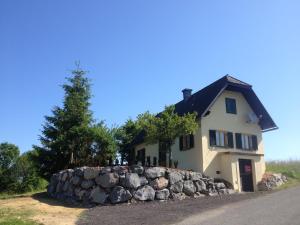 a house with a stone wall in front of it at Casa Anna in Bad Gleichenberg