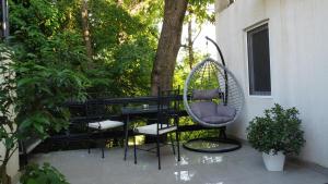 a porch with a chair and a swing at Jelena Lapčići Budva in Budva