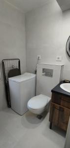 a white bathroom with a toilet and a sink at Jelena Lapčići Budva in Budva +12 photos