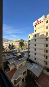 ein Blick auf ein Gebäude von einem Balkon in der Unterkunft Elegant studio apartment A2 in La Playa Bejarano