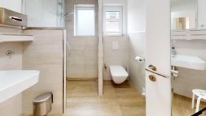 a small bathroom with a toilet and a sink at Haus Ostwind OSTWIND 'Lütje Pläseer' in Langeoog +11 photos