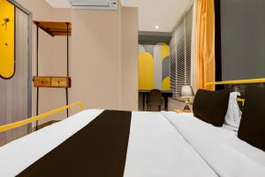 a bedroom with a bed with a black and white comforter at Super Townhouse Vaishali Nagar Jaipur Formerly Pentagon Boutique Hotel in Jaipur