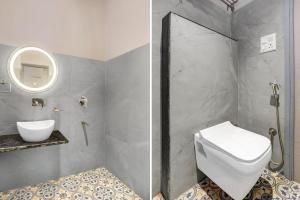 a bathroom with a toilet and a sink and a mirror at Super Townhouse Vaishali Nagar Jaipur Formerly Pentagon Boutique Hotel in Jaipur