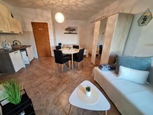 a living room with a couch and a table at Apartmani AS in Jezera