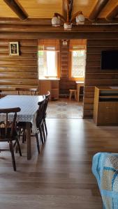 a dining room with a table and chairs in a cabin at Relax in Melʼniki