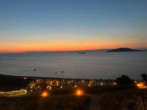 a view of a beach at night with the ocean at Ege Naz 1 in Marmara +3 photos