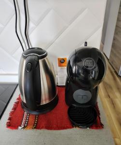 a toaster and a tea pot sitting on a rug at Vivere in Slovenia in Plavje