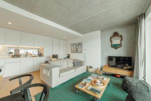 a living room with a couch and a table at Beach & Sun Apartment by Vacationy in Bomfim