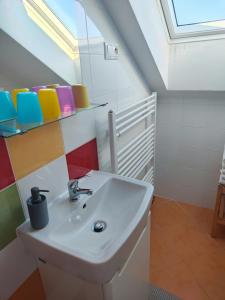 a bathroom with a sink and a skylight at Demänova 238 in Liptovský Mikuláš +32 photos