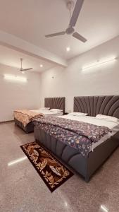 a bedroom with two beds and a ceiling at J Terminal Hotel & Cafe in Barkot +42 photos