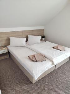 a large white bed with two pillows on it at Demänova 238 in Liptovský Mikuláš