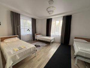 a bedroom with two beds and a window at Luxe Hotel in Kazarman