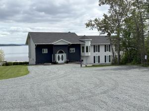 a large house with a driveway in front of it at Haileybury Lakehouse in Haileybury