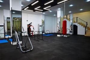 a gym with treadmills and equipment in a room at Coral Hotel in Duhok