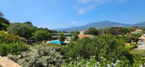 a resort with a swimming pool and mountains in the background at T2 Résidence Dolce & Vita B3 avec piscine in Propriano
