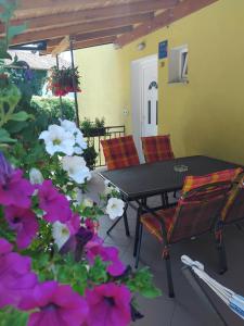 a patio with a table and chairs and flowers at Apartment Matulji in Matulji