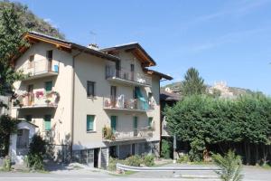 a large apartment building with balconies and trees at Appartamento Pommier in Saint-Pierre