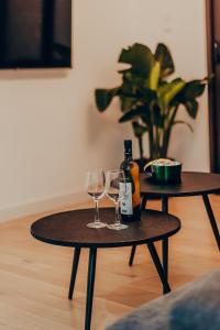 a table with two glasses and a bottle of wine at Dreamy Glyfada Apartment in Athens